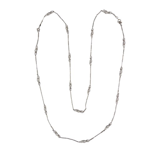 Early 20th century diamond and platinum chain necklace, c.1915, spaced by three-stone diamond stylised foliate motifs,